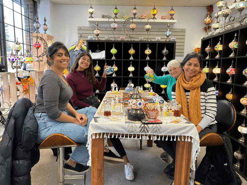 Participants creating Turkish mosaic lamps at a DIY art workshop in Toronto, Ontario. A hands-on experience in a mosaic lamp studio