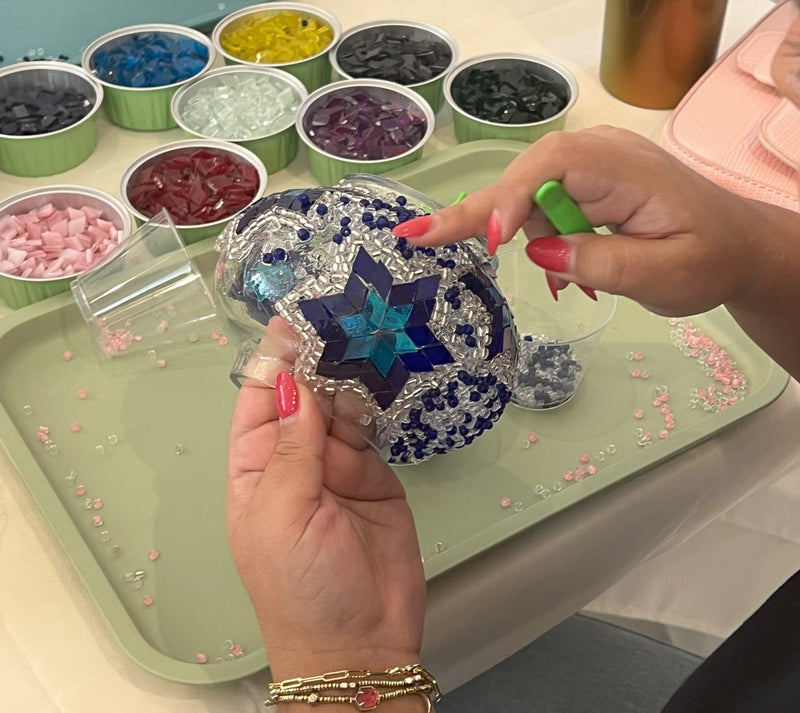 Participant designing a colourful Turkish mosaic lamp at DIYLabs workshop in Toronto, Canada
